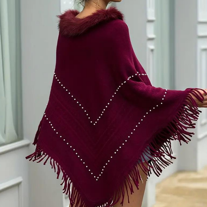 Eftychia's elegant knitted poncho with unique details for modern women
