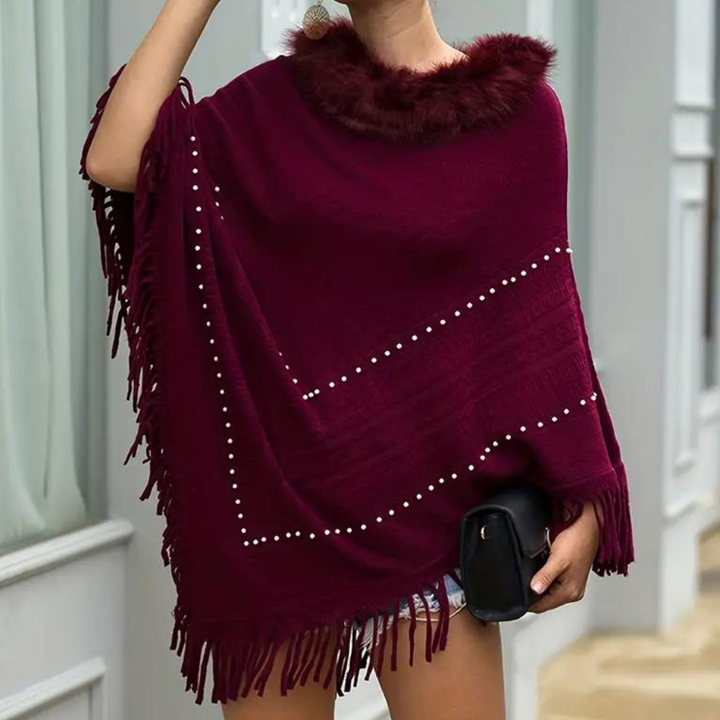 Eftychia's elegant knitted poncho with unique details for modern women